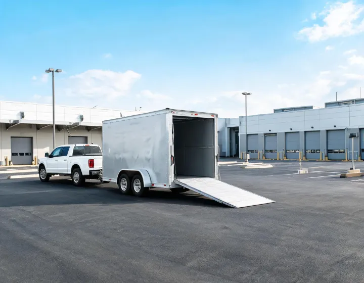 Custom aluminum enclosed cargo trailer at a commercial loading yard